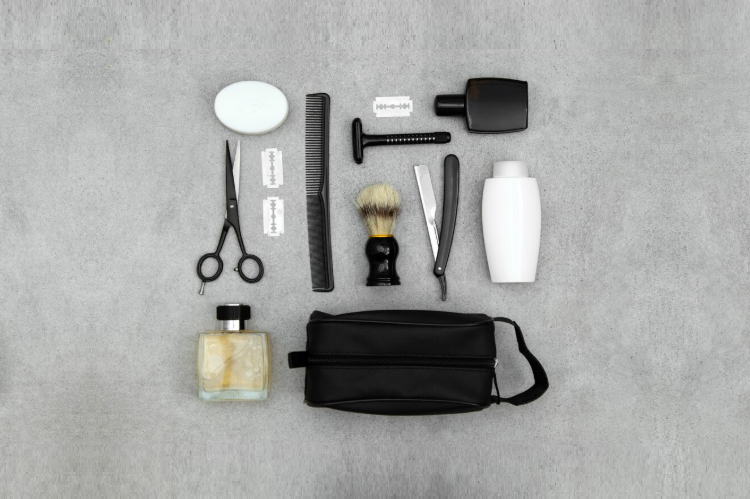 A set of beard grooming tools for men, including a trimmer, comb, brush and scissors